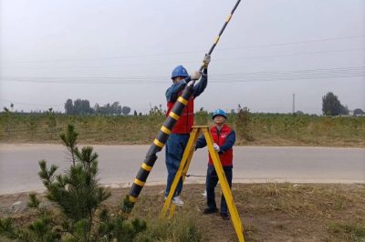 深入田間地頭為配電線路桿塔拉線安裝反光膜、拉線護套